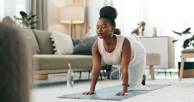 Yoga, legs or black woman stretching in home or house studio for wellness, peace or balance. Pilates, flexible or zen African person in donkey pose for energy training, breath or holistic exercise