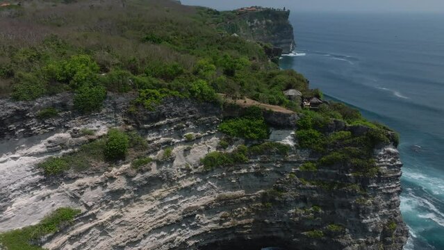 Cliff aerial top down view of a rocky coastline in Uluwatu, Bali. 