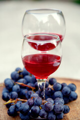 Glasses with red wine and a bunch of grapes. Composition with red wine in glasses and a bunch of grapes. side view, top view.