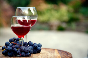 Glasses with red wine and a bunch of grapes. Composition with red wine in glasses and a bunch of grapes. side view, top view.