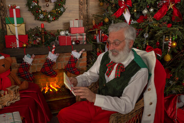 Obraz premium Santa Claus rejoicing with letters and mail in his post office indoors Log Cabin at the North Pole