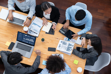Top view multiracial analyst team use BI dashboard display on laptop screen, analyzing financial data for strategic decision. Fintech analyzes marketing indicators. Concord