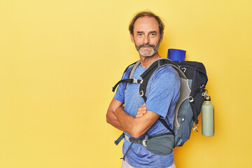Fototapeta na wymiar Adventurous man with mountain backpack in studio