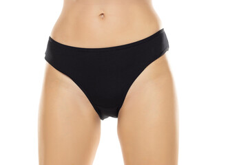 front view of female hips with black panties on white background