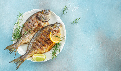 roasted dorado or sea bream fish with lemon, organic healthy products. Detox and clean diet concept. place for text, top view