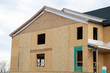 unfinished plywood house with a roof frame real work