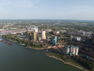 Aerial drone view of an electricity genration plant, cooling towers, some stacks.