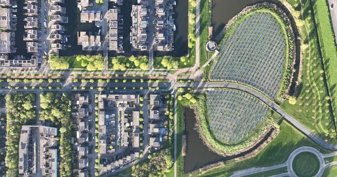 Top down view on modern sustainable neighborhood in Almere, Netherlands, with a focus on district heating and a solar panel island.