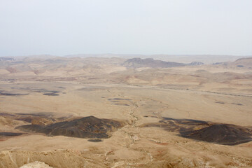 Fototapeta na wymiar Open Negev Desert in South Israel. Sand dunes with dry air on a summer day.