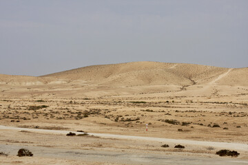 Open Negev Desert in South Israel. Sand dunes with dry air on a summer day.