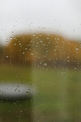 Water drops on glass texture abstract autumn nature background,Selective focus. Natural pattern of rain drops on window glass surface.
