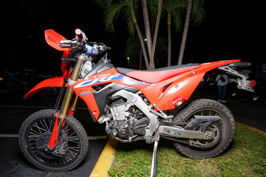 Night flash photo of a red Honda dirt bike motocross
