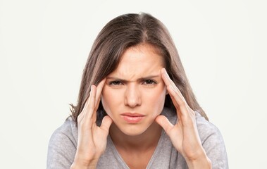Young beautiful woman touching head feeling stress