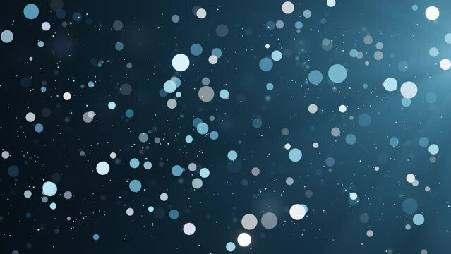 Blue shimmering particles on dark background. Bokeh glitter dust seamless loop animation.