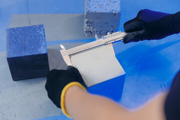 Check size and controls quality of concrete cube in laboratory. Concept industry lab for testing building materials
