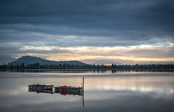 Cloudy Dal lake landscape srinagar Kashmir india at sunrise with shikara