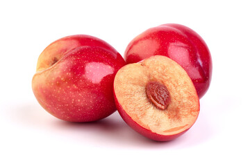 Red plum with juicy slice, isolated on white background.