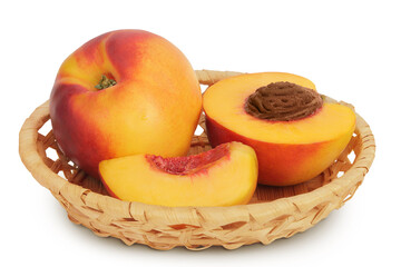 Ripe nectarine fruit with half in a wicker basket isolated on white background with full depth of field