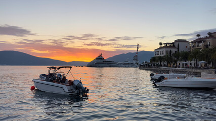 Boat at sunset.  Boats, yachts at Adriatic sea bay at sunset. Porto Montenegro, Tivat