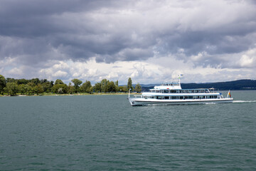 Lake Constance with passenger ship near Konstanz in summer with clouds