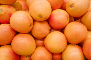 Background image: fruits of fresh ripe grapefruits of the new harvest