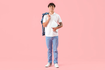 Fototapeta premium Male programmer with laptop on pink background