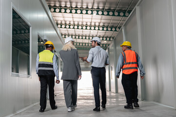 Team engineers workers planning and talking in empty warehouse to design the arrangement of product...