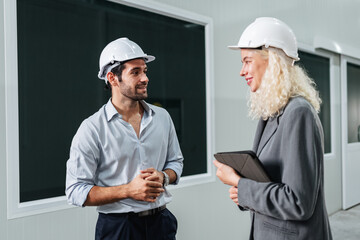 Team engineers workers planning and talking in empty warehouse to design the arrangement of product...