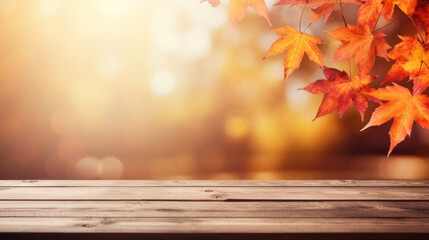 Naklejka na ściany i meble Plattform aus Holzdielen mit hereinragenden Herbstblättern und einem herbstlichen Wald als Bokeh-Hintergrund.