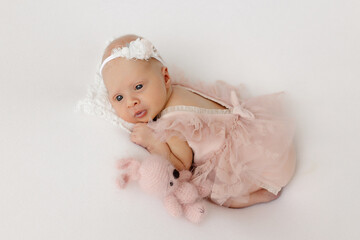 newborn girl in a beautiful dress.newborn baby on a white background