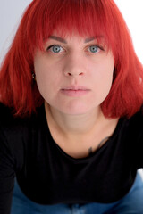 A young attractive woman with a short orange hairstyle