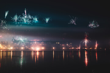 New Year's Eve midnight fireworks over the promenade of Peterhausen, taken from the waterfront next...