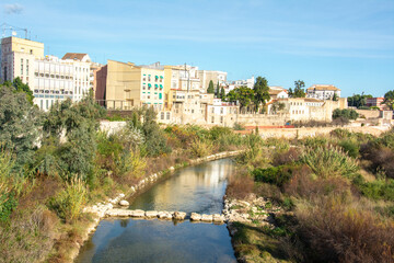 Fototapeta premium View over the Serpis River and vegetation in Gandia City in the Valencian Community, eastern Spain on the Mediterranean