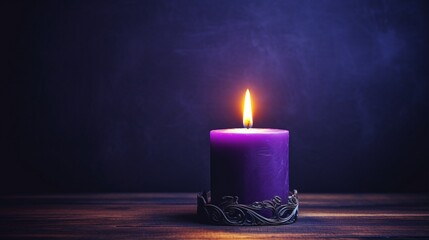 A single lit candle on a dark violet table.
