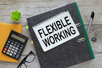 Flexible working text in notepad in a folder. near a yellow notepad with a calculator