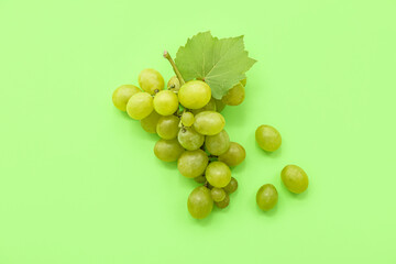 Sweet green grapes with leaf on color background