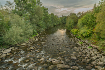 Roznovska Becva river in Valasske Mezirici in autumn cloudy evening