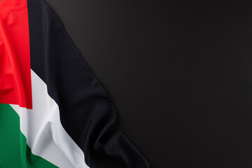 The palestinian nation's lament concept. Top view shot of Palestinian flag on black background with...