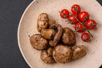 Delicious juicy whole champignons baked on the grill with salt and spices