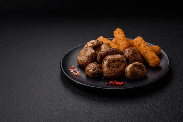 Delicious juicy whole champignons baked on the grill with salt and spices