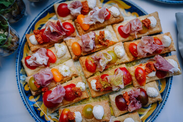 Small bread rolls filled with ham and tomato make for a delicious and simple sandwich option.