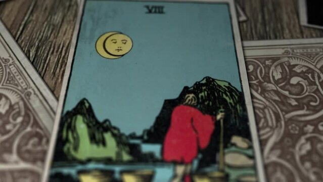 Rotterdam, Netherlands - January 31, 2021. Tarot Card Eight Of Cups shows a man walks away from the eight cups standing in the foreground. Chance of Better Life. Future Telling Chance. Chance of Luck.