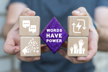 Man holding colorful blocks sees inscription: WORDS HAVE POWER. Concept of words have power. Copywriting storytelling marketing. Business and education english language learning concept.