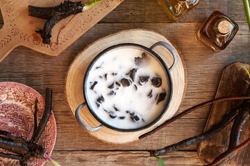 Sliced comfrey root in rendered solidified pork lard - preparation of homemade ointment