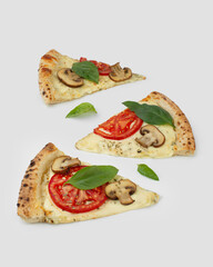Falling slice of pizza with ingredients isolated