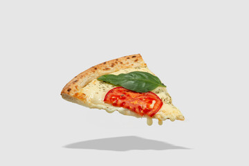 Falling slice of pizza with ingredients isolated
