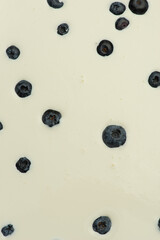 Texture of cream with blueberries background