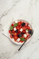 Tomato and basil salad on stone table