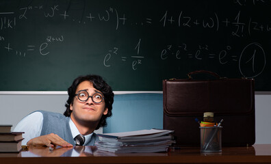 Young math teacher in front of chalkboard