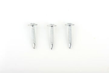 Zinc screws with a round press washer on a white background. Detailed shot of fittings and fasteners.